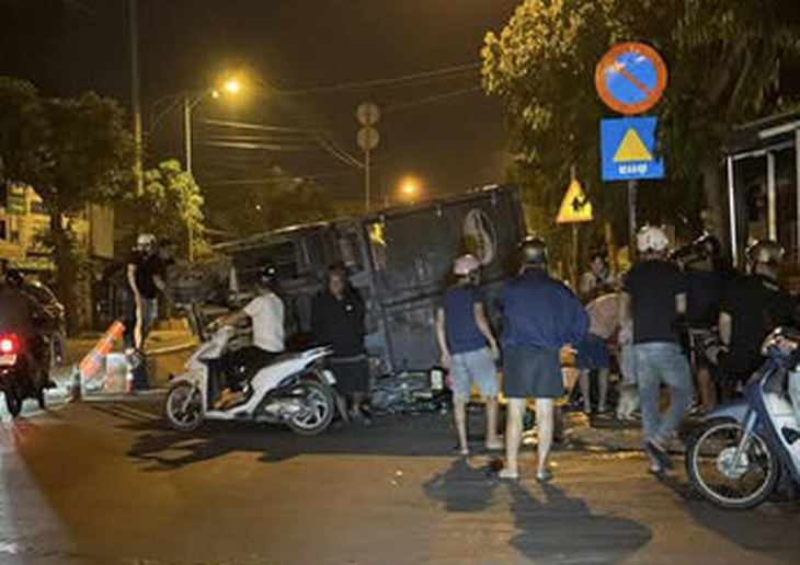 Xe tải tông dải phân cách, lật ngang đè xe máy